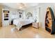 Serene bedroom with white bedding, wood floors, and ample natural light from multiple windows at 2593 W Vina Del Mar Blvd, St Pete Beach, FL 33706