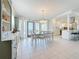 Elegant dining area with a charming chandelier, leading to a delightful outdoor space at 2593 W Vina Del Mar Blvd, St Pete Beach, FL 33706