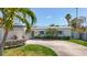 Charming single-story home with circular driveway and tropical landscaping at 2593 W Vina Del Mar Blvd, St Pete Beach, FL 33706