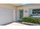 Close-up of front door entrance with beautiful flower box and updated garage door at 2593 W Vina Del Mar Blvd, St Pete Beach, FL 33706