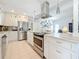 Stylish kitchen with stainless appliances, white cabinets and modern decorative touches at 2593 W Vina Del Mar Blvd, St Pete Beach, FL 33706
