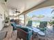 Spacious covered patio offers multiple seating areas with views of the pool and backyard at 2593 W Vina Del Mar Blvd, St Pete Beach, FL 33706