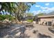 Brick patio area in backyard offers dining and lounging space, with lush landscaping at 2604 Manor Oak Dr, Valrico, FL 33596