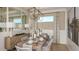 Elegant dining room with modern chandelier, stylish chairs, and plenty of natural light at 29505 Velletri Ln, Wesley Chapel, FL 33543