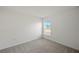 Bright bedroom with a window and plush neutral carpeting at 21237 Pemberton Ave, Port Charlotte, FL 33981