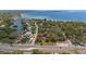 Aerial view showing the lot with a home surrounded by mature trees near the water at 3143 Phoenix Ave, Oldsmar, FL 34677