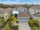 Aerial view of a beautiful home with well maintained landscaping and a paver driveway at 319 Shore Crab Way, Apollo Beach, FL 33572