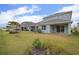 View of the backyard with a well-maintained lawn and blue siding at 319 Shore Crab Way, Apollo Beach, FL 33572