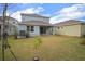 Backyard with a well-maintained lawn and small fruit tree at 319 Shore Crab Way, Apollo Beach, FL 33572