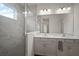 This well lit bathroom offers double sinks, lots of counter space, and a glass enclosed shower at 319 Shore Crab Way, Apollo Beach, FL 33572