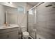 Modern bathroom featuring a glass-enclosed shower, a vanity with sink, and neutral tones at 319 Shore Crab Way, Apollo Beach, FL 33572