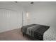 Bedroom with double closet doors, neutral carpet, and entry to another room at 319 Shore Crab Way, Apollo Beach, FL 33572