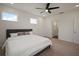This bedroom features a plush carpet, a modern ceiling fan, and an ensuite bathroom for added privacy at 319 Shore Crab Way, Apollo Beach, FL 33572