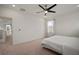 A bedroom features plush carpet, a modern ceiling fan, and a tranquil view at 319 Shore Crab Way, Apollo Beach, FL 33572