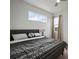 This bedroom features a large window for natural light and stylish black and white decor at 319 Shore Crab Way, Apollo Beach, FL 33572