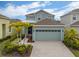 Beautiful home featuring a two-car garage, well-maintained lawn, and elegant landscaping at 319 Shore Crab Way, Apollo Beach, FL 33572