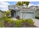 Charming home featuring a two-car garage, well-manicured landscaping, and an inviting front entrance at 319 Shore Crab Way, Apollo Beach, FL 33572