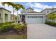 Charming home featuring a two-car garage, well-manicured landscaping, and an inviting front entrance at 319 Shore Crab Way, Apollo Beach, FL 33572