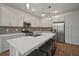 Stylish kitchen featuring a large island with seating, stainless steel appliances, and ample storage at 319 Shore Crab Way, Apollo Beach, FL 33572