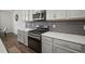 Well-equipped kitchen with stainless steel appliances, gray cabinets, and quartz countertops at 319 Shore Crab Way, Apollo Beach, FL 33572