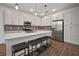 Bright, open kitchen with white cabinets, stainless steel appliances, and a large island with seating at 319 Shore Crab Way, Apollo Beach, FL 33572