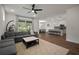 Bright and airy living room with a ceiling fan, sliding glass doors, dining area, and kitchen island with seating at 319 Shore Crab Way, Apollo Beach, FL 33572