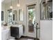 Contemporary bathroom with modern lighting and vanity, and a view to the pool at 33 Sunset Bay Dr, Belleair, FL 33756