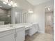 Bathroom with dual sinks, vanities, and a tiled shower at 35587 Stableton Ln, Zephyrhills, FL 33541