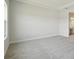 Spacious bedroom with plush carpeting and entry to the bathroom at 35587 Stableton Ln, Zephyrhills, FL 33541