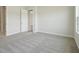 Bedroom featuring neutral paint and carpet with a door leading to the living area at 35587 Stableton Ln, Zephyrhills, FL 33541