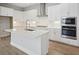 Modern kitchen with stainless steel appliances, quartz countertops, and white cabinets at 35587 Stableton Ln, Zephyrhills, FL 33541