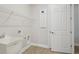 Laundry room featuring utility sink, wire shelving, and neutral luxury vinyl plank flooring at 35587 Stableton Ln, Zephyrhills, FL 33541