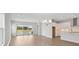 Open-concept living room and kitchen area with modern finishes and plenty of natural light at 35587 Stableton Ln, Zephyrhills, FL 33541