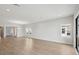 Expansive living room featuring abundant natural light, hardwood floors, and neutral paint at 35587 Stableton Ln, Zephyrhills, FL 33541
