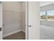 Walk-in closet featuring wire shelving adjacent to carpeted bedroom with windows at 35587 Stableton Ln, Zephyrhills, FL 33541