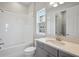 Bathroom with a combination tub and shower and vanity sink with bright natural lighting at 35593 Stableton Ln, Zephyrhills, FL 33541