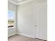 Light and airy bedroom featuring a bright window, modern wood flooring, and crisp white trim at 35593 Stableton Ln, Zephyrhills, FL 33541