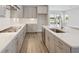 Modern kitchen showcasing white countertops, stainless steel appliances, and a view of the beautiful backyard at 35593 Stableton Ln, Zephyrhills, FL 33541