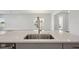 Island kitchen sink with modern faucet and white countertops, bright and spacious with natural light at 35593 Stableton Ln, Zephyrhills, FL 33541