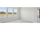 Bright room with three windows offering exterior views and a sliding glass door at 35593 Stableton Ln, Zephyrhills, FL 33541