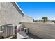 Outdoor patio view displaying seating and an AC unit beneath a clear, sunny sky at 360 8Th N Ave # 3, Tierra Verde, FL 33715