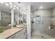 Modern bathroom featuring a glass shower, stone counters, and ample lighting at 360 8Th N Ave # 3, Tierra Verde, FL 33715