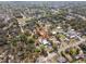 Aerial view of the property in a neighborhood, surrounded by lush greenery and neighboring houses at 4020 Amber Rd, Valrico, FL 33594