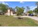Backyard exterior with a shed, a car and overgrown grass at 4020 Amber Rd, Valrico, FL 33594
