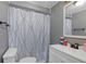 Bathroom featuring a vanity with a sink, a mirror, and a stylish patterned shower curtain at 4020 Amber Rd, Valrico, FL 33594