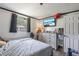 Cozy bedroom featuring a comfortable bed, TV, and dresser with natural light from the window at 4020 Amber Rd, Valrico, FL 33594