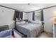 Bedroom featuring a cozy bed with a soft blanket and a window view at 4020 Amber Rd, Valrico, FL 33594