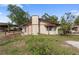 Shows the exterior with a yard, trees, and a chimney at 4020 Amber Rd, Valrico, FL 33594