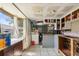 The kitchen features white tile floors, empty cabinets, and natural light from the window at 4020 Amber Rd, Valrico, FL 33594