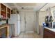 Renovation view of kitchen area, including cabinets, a white refrigerator and tiled flooring at 4020 Amber Rd, Valrico, FL 33594
